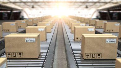 Boxes on conveyor rollers in warehous