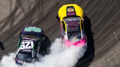 formula drift race cars sliding and smoking tires side by side overhead shot