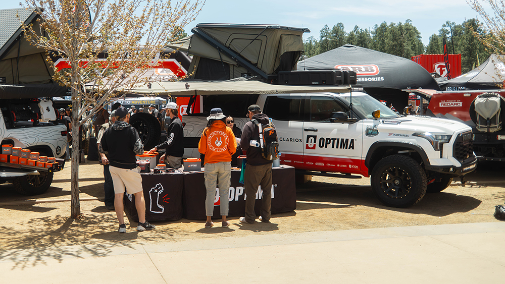 People at exhibitor booth at Overland Expo West.