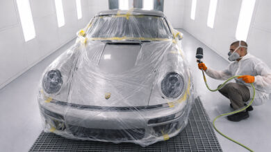 Person prepping Porsche 911 for painting