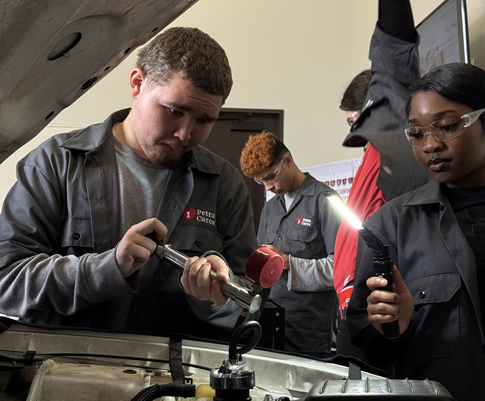 Petra Cares students engaged in ASE-certified automotive training