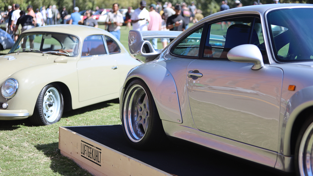 Porsche cars on display at Luft 11 with crowd in background