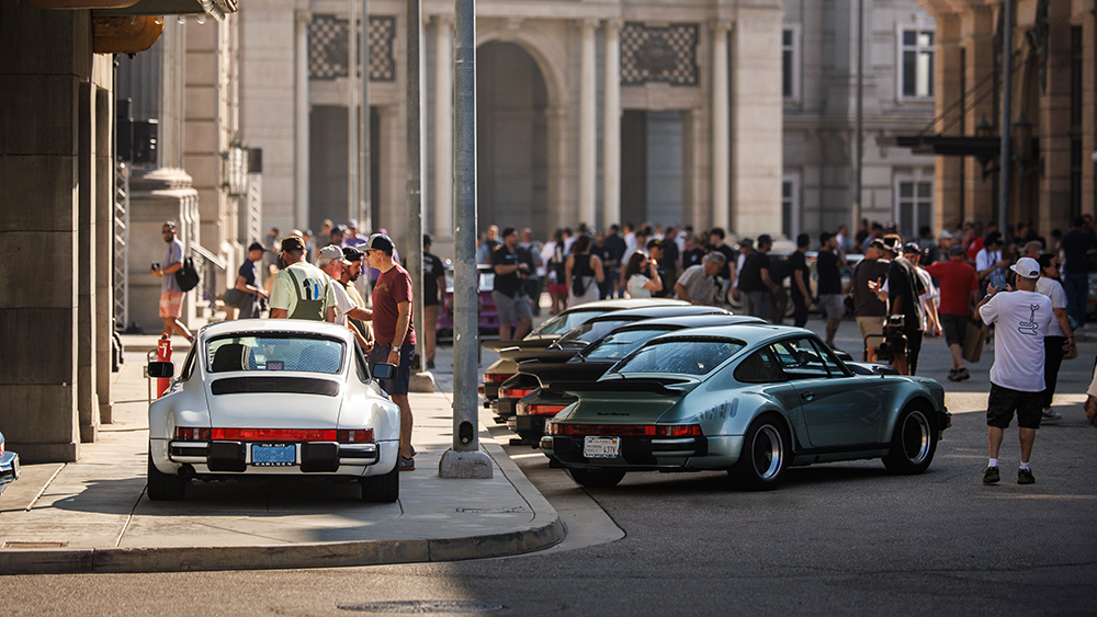 Porsche cars on display in street at Luft 11 with crowd viewing the cars