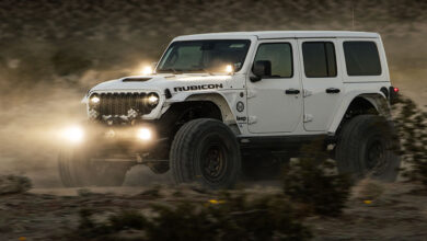 Jeep Rubicon racing through rocky terrain
