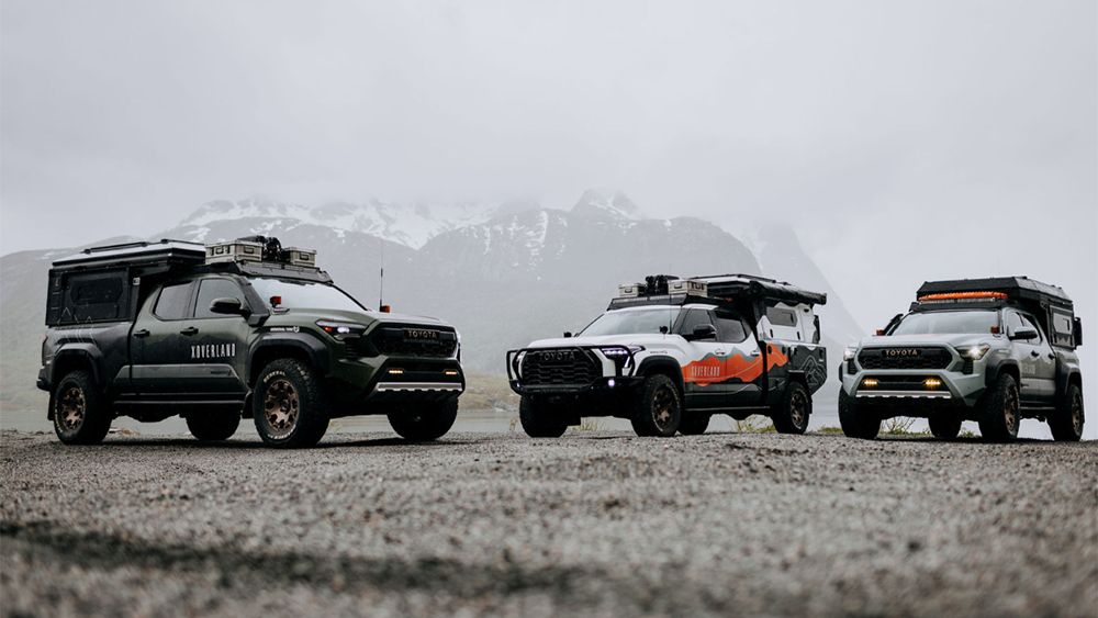 Three XOVERLANDs parked on gravel road in front of snowy mountain
