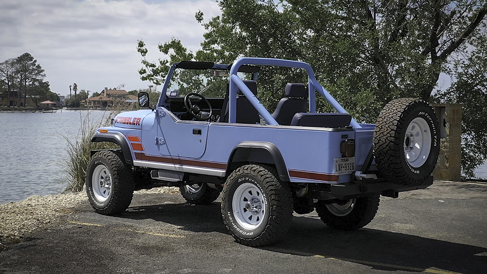 Vigilante Scrambler Jeep parked next to water from rear