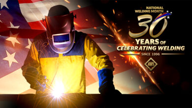 Welder with sparks and National Welding Month logo