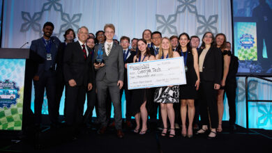 Georgia Tech team holding large check on stage