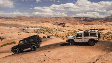 Two Ineos Grenadiers traveling over rocky terrain
