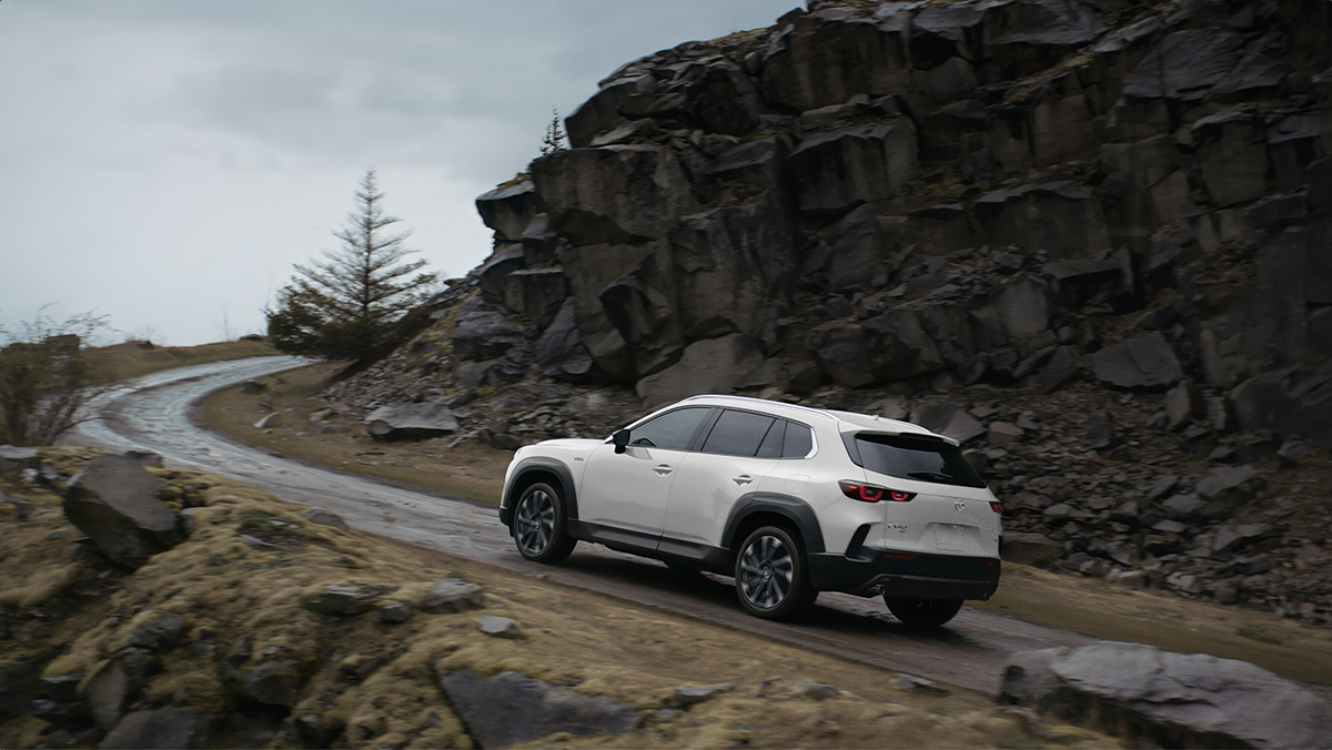 Mazda CX-50 Hybrid driving up mountain road