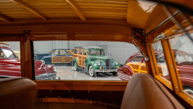 Photo of wood-sided cars through the window from the interior of a car