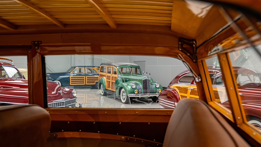 Photo of wood-sided cars through the window from the interior of a car