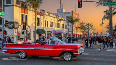 Red vintage car on street at sunset at Pismo Beach Car Show