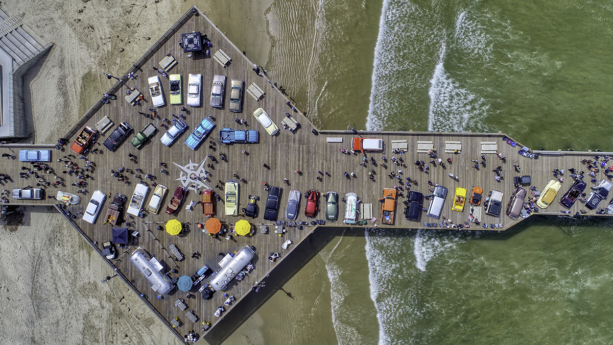Aerial shot of pier full of vitage cars for the Pismo Beach Car Show