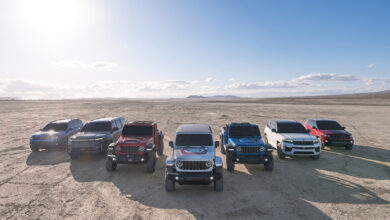 Line of various jeep models parked in a row in the desert