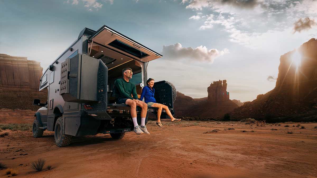 Storyteller Overland GXV WILD in desert with couple sitting on FlipOut