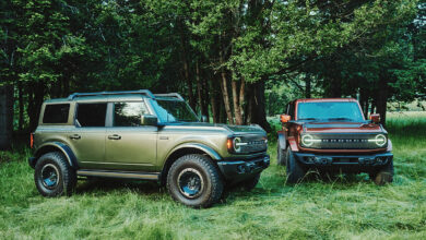 Two 2027 Bronco Filsons parked in grassy area in the woods