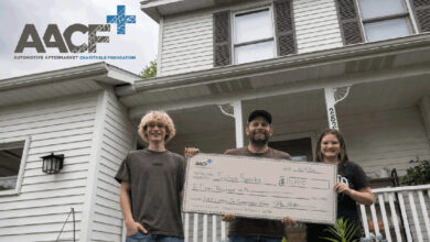 AACF Classic Car Sweepstake Winner and family holding large check