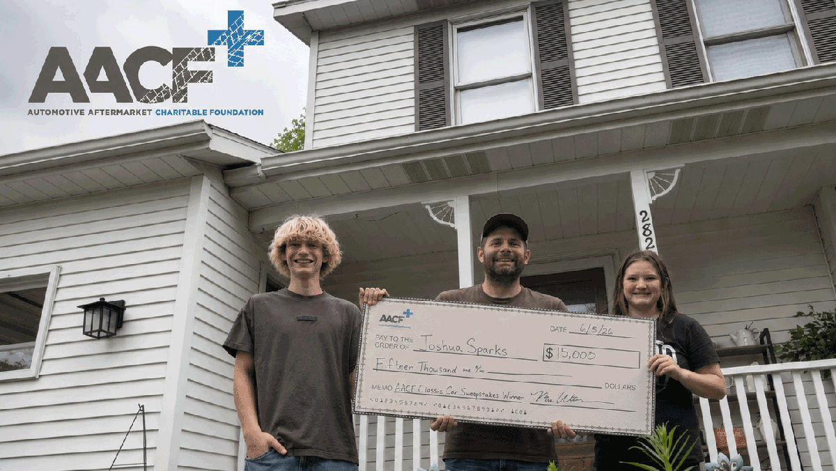 AACF Classic Car Sweepstake Winner and family holding large check