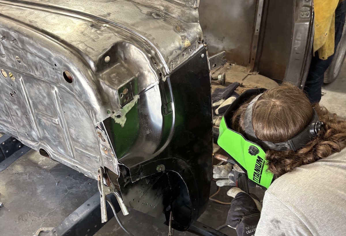 acme chop shop welder working on frame