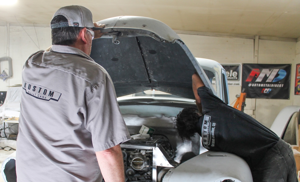 acme chop shop under hood of classic truck