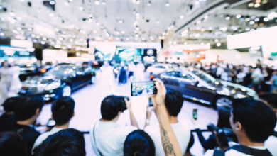 Blured image of car and motor exhibition show event