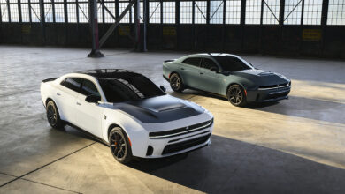 Gas-powered, 550-horsepower 2027 Dodge Charger Scat Pack models, shown in White Knuckle and Sub-Zero exterior colors parked in warehouse