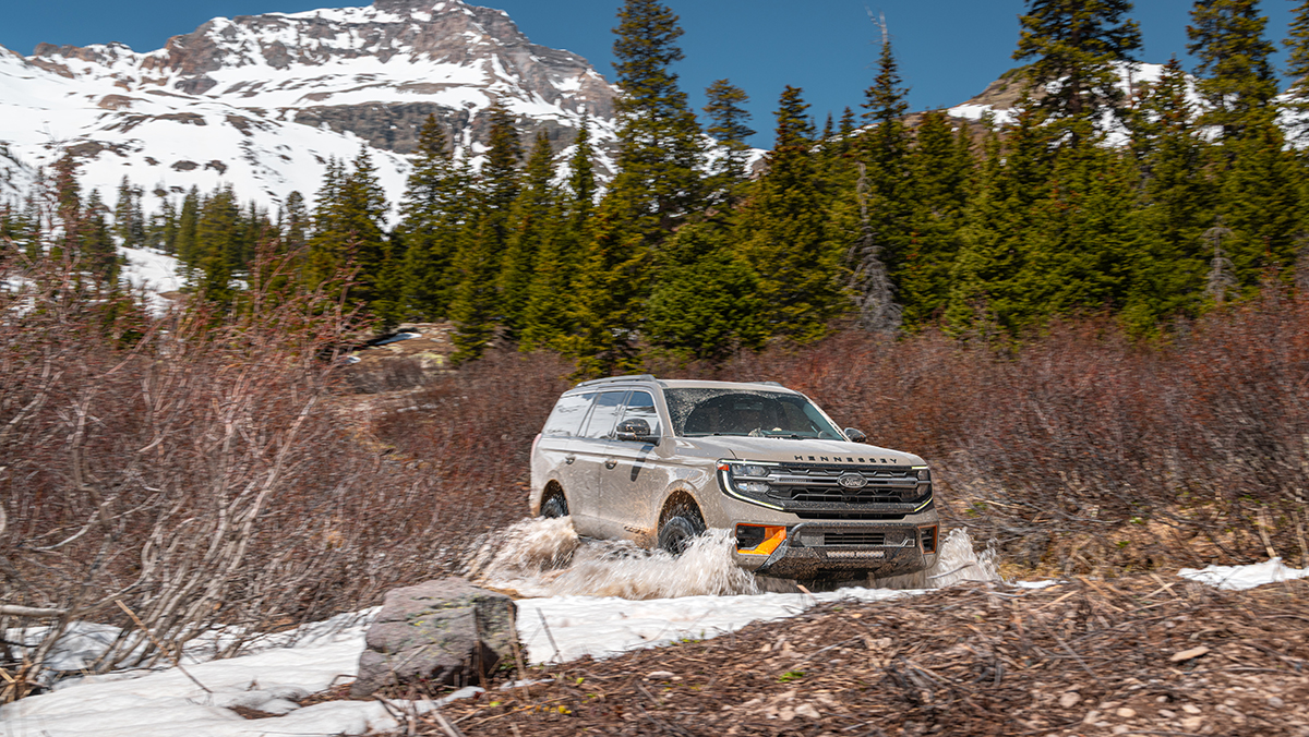 Hennessey Ford Expedition Tremor VelociRaptor SUV driving through snow and water
