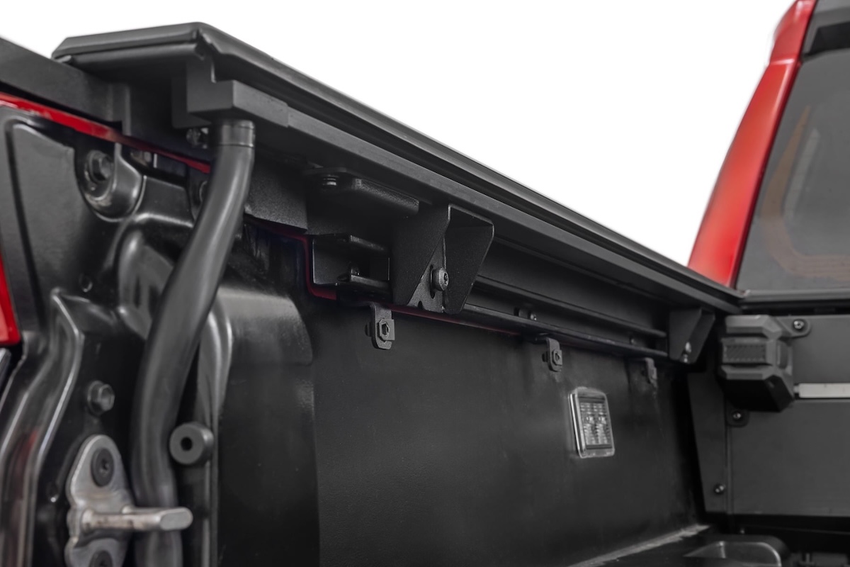 tonneau rough country under rail mechanism closeup red truck
