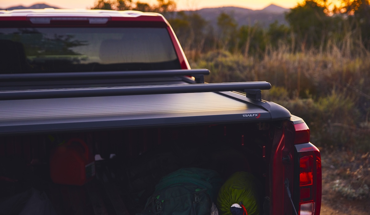tonneau trailfx cover on truck bed at sunset with rack and gear