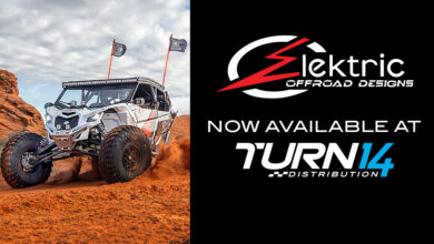 Side-x-Side running in clay next to Elektric Offroad Designs and Turn 14 Distribution logos