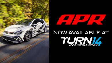 APR and Turn 14 Distribution Logos with Volkswagen vehicle on road