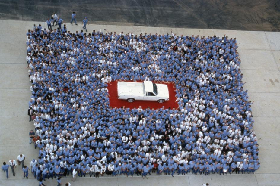 First Nissan pickup truck produced in America in 1983 surrounded by crowd of people