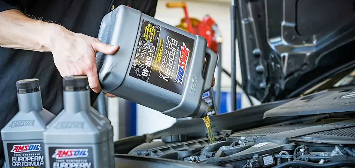 Import Performance AMSOIL engine oil pour silver bottle