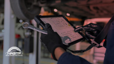 Auto technician examining data on tablet
