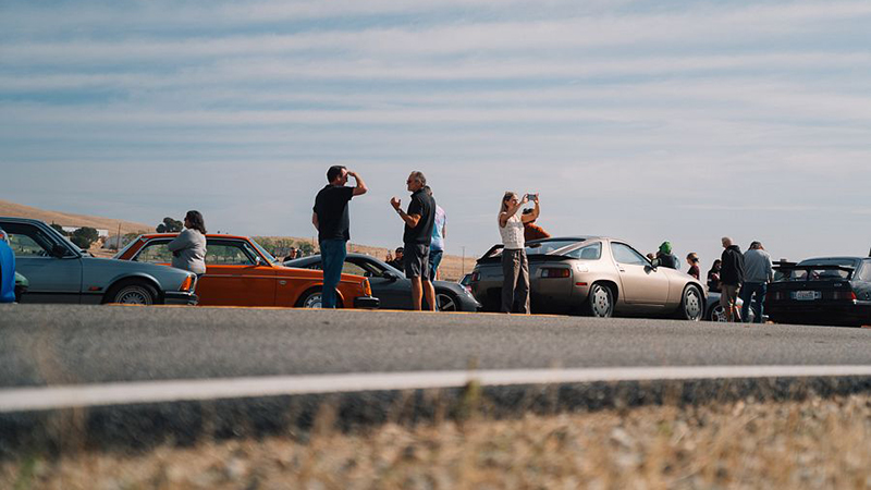 Cars and people on side of road