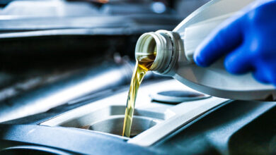 automobile oil is poured into the engine close up. pouring new o