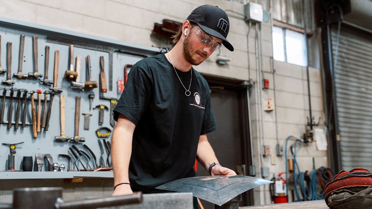 Cameron Maguire practices metal shaping as part of his auto restoration education.