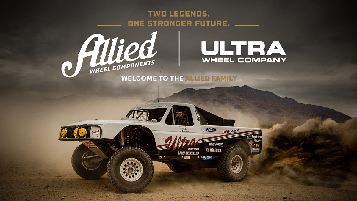 ALLIED nd ULTRA logos above truck kicking up sand