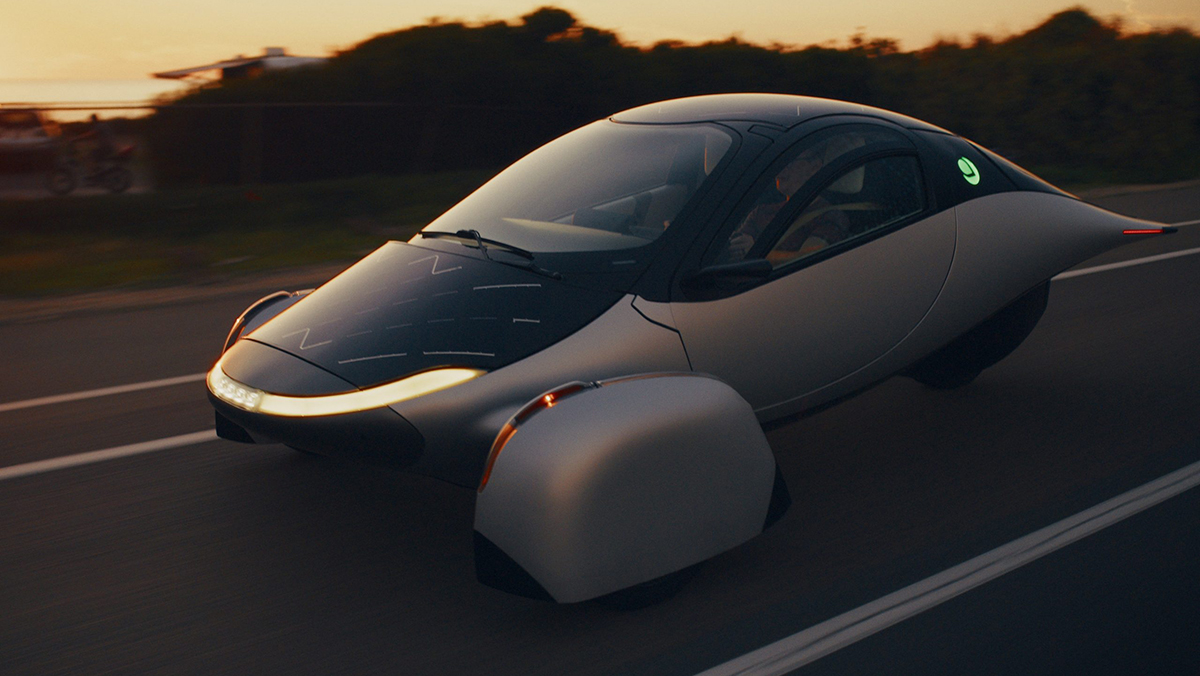 Aptera Solar Electric Vehicle on road at sunset