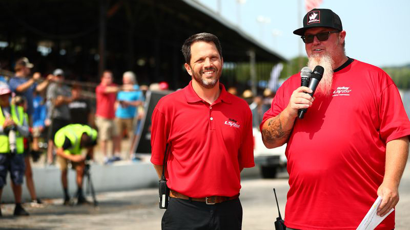 Bill Tichenor talking to announcer at racetrack