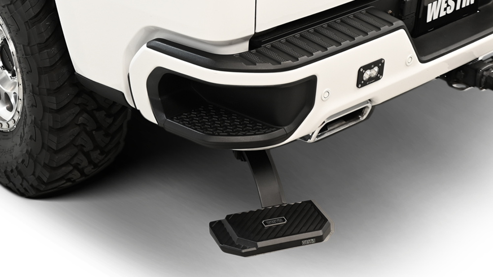 The all-new Westin Manual Retractable Bed Step extened below rear bumper of truck