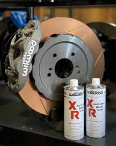 Road Racing Wilwood XR Race-Only Brake Fluid in front of rotor & caliper