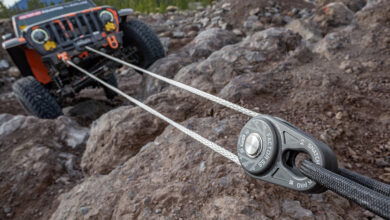Jeep using winch to pull itself over rocks