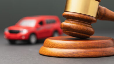 The toy car and the judge gavel are on the table.