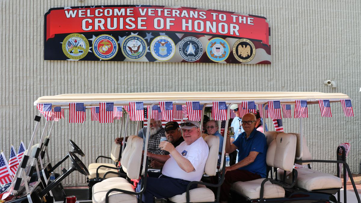 Vetrans in golf cart at Cuise of Honor during Iola Car Show