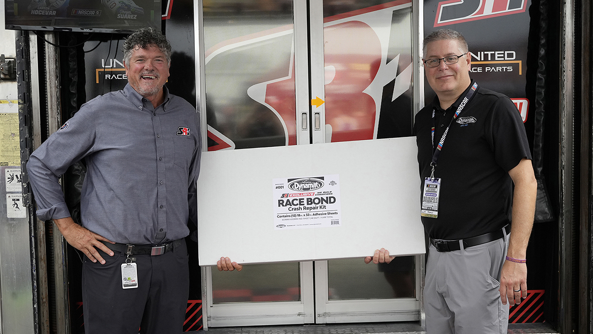Scott and Greg of SRI Performance holding Race Repair kit in front of building