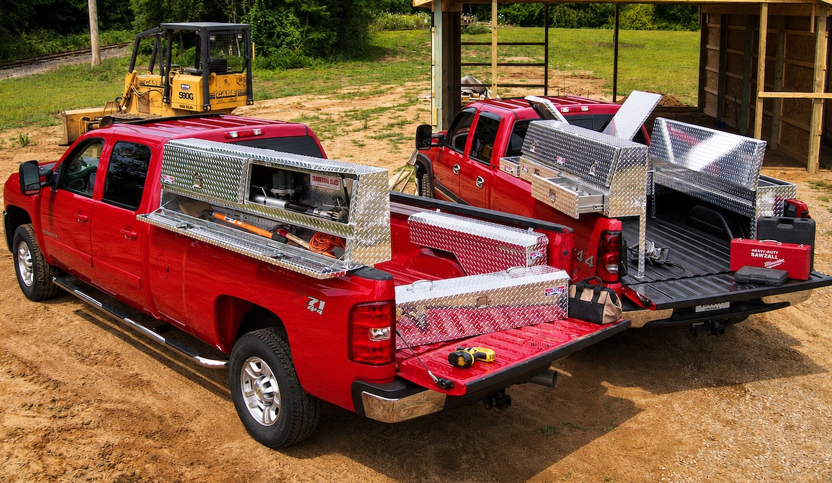 toolboxes cargo carriers red silverado trucks at worksite with silver toolboxes open
