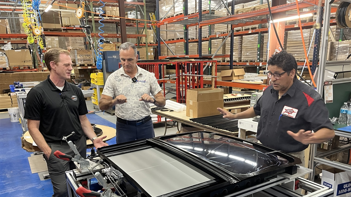 Host Jesse Stoddard & Bill North examine a sunroof assembly at Champion Auto Systems