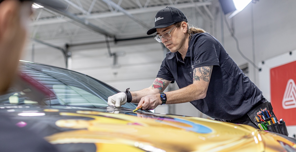 lettering express avery dennison trainer charlie trujillo lays a hood graphic